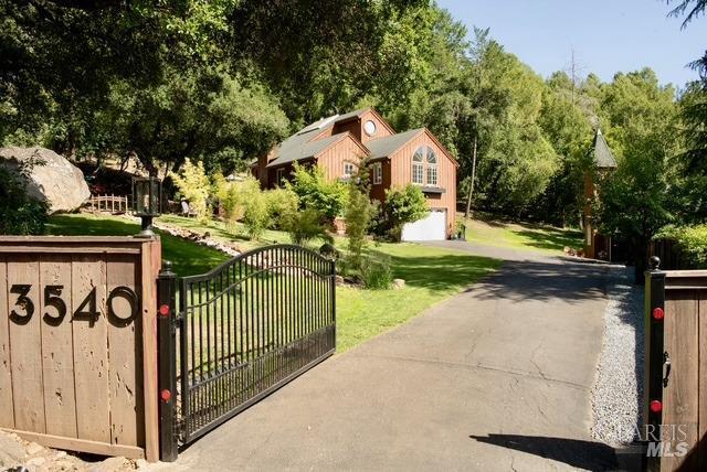 view of gate featuring a lawn