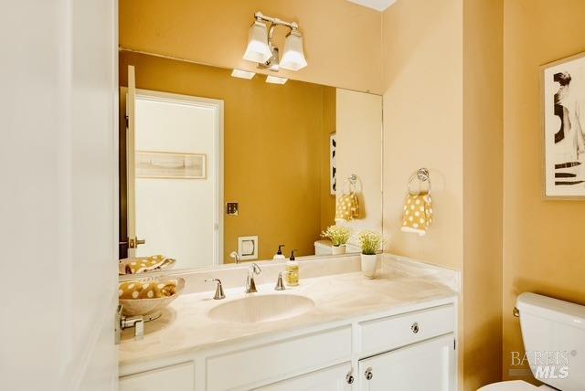 half bath with vanity and toilet