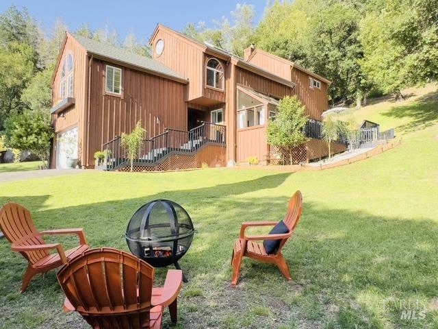 view of property's community with a garage and a lawn