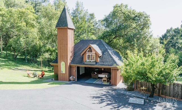 detached garage featuring fence