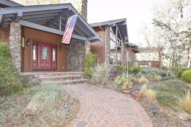 doorway to property with a pergola