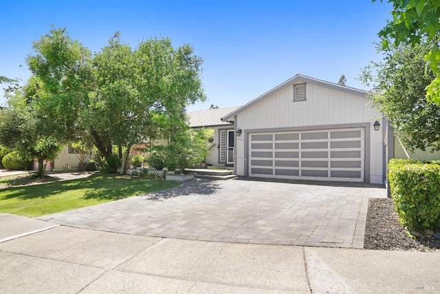 ranch-style home featuring a front lawn and a garage