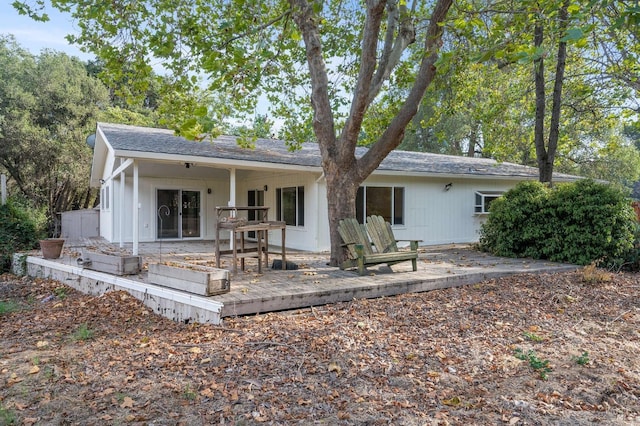 back of house with a patio and a wooden deck