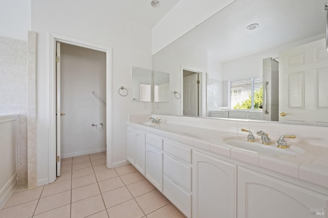 bathroom with tile floors and double sink vanity