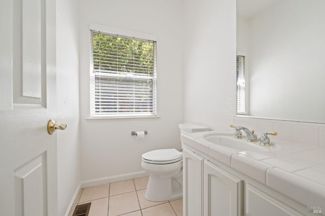 bathroom with vanity, toilet, and tile floors