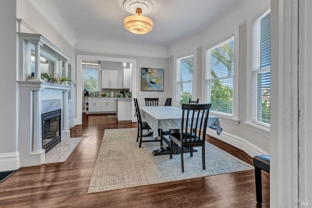 dining area with visible vents, a fireplace, baseboards, and dark wood finished floors