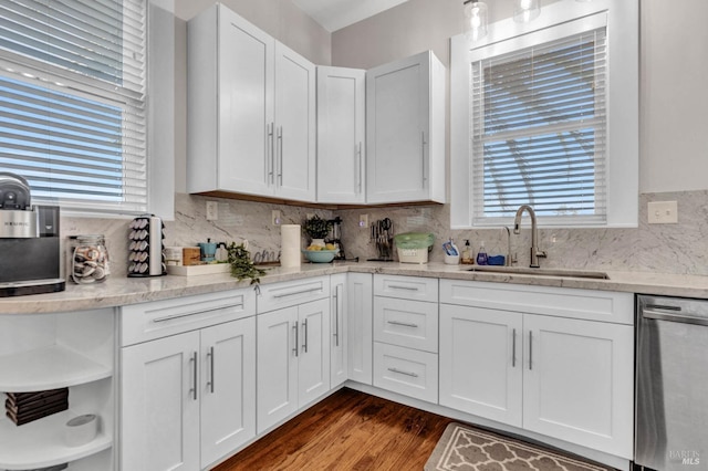 kitchen with a sink, white cabinetry, open shelves, and dishwasher