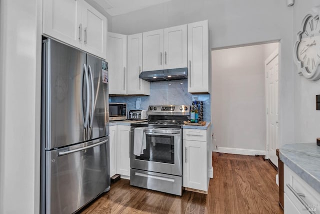 kitchen featuring stainless steel appliances, white cabinets, and under cabinet range hood