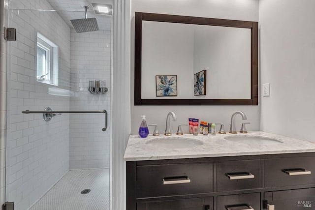 bathroom with double vanity, a sink, and a shower stall