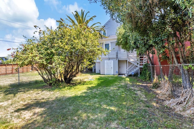 view of yard with stairway and fence