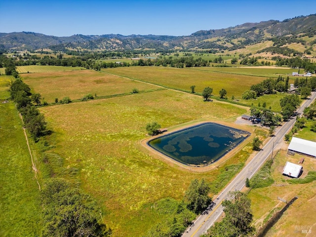 birds eye view of property featuring a mountain view and a rural view