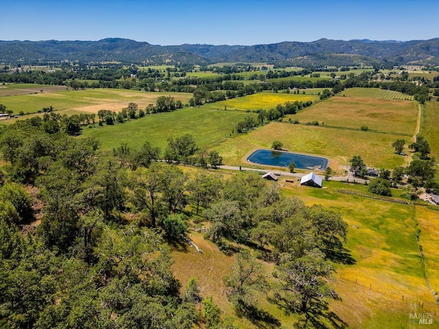 birds eye view of property with a mountain view and a rural view