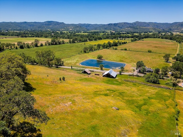 drone / aerial view featuring a water and mountain view and a rural view