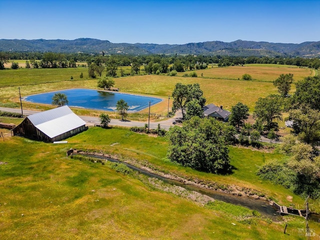 drone / aerial view with a mountain view and a rural view