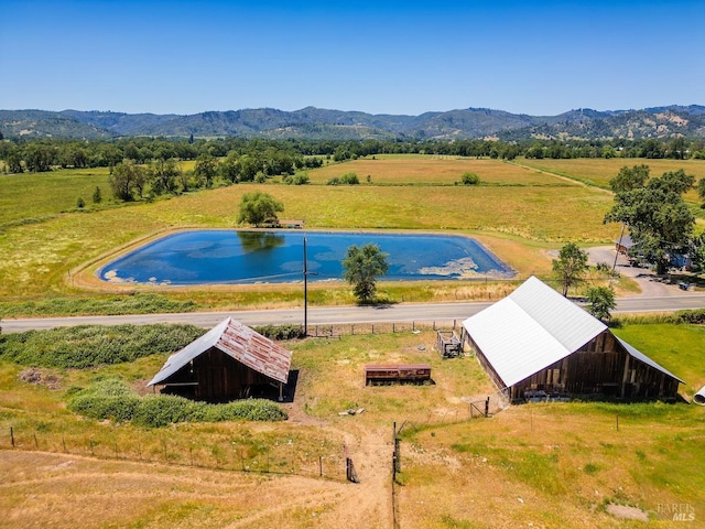 birds eye view of property featuring a mountain view and a rural view