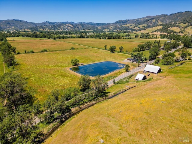 drone / aerial view featuring a mountain view and a rural view