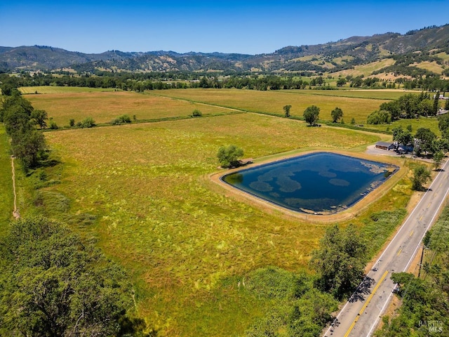 drone / aerial view featuring a mountain view and a rural view