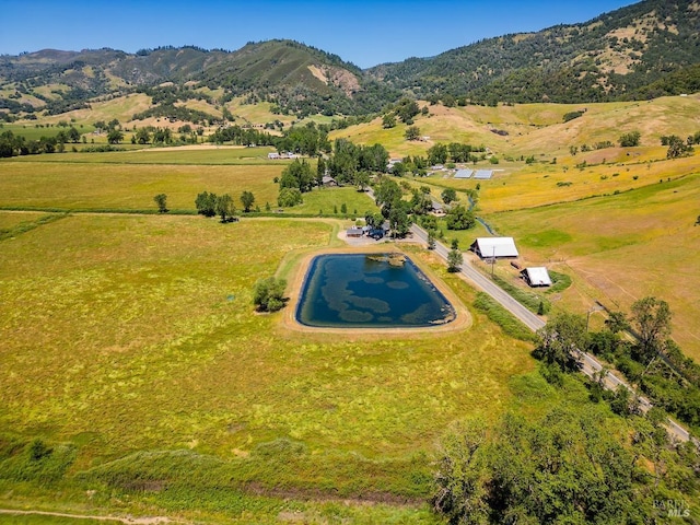 drone / aerial view featuring a mountain view and a rural view