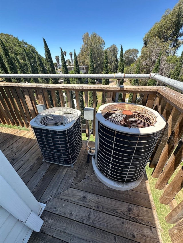 wooden deck featuring cooling unit