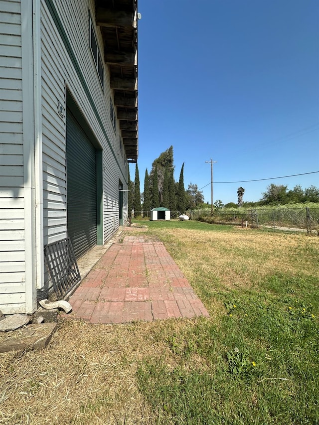view of yard with a patio and an outbuilding