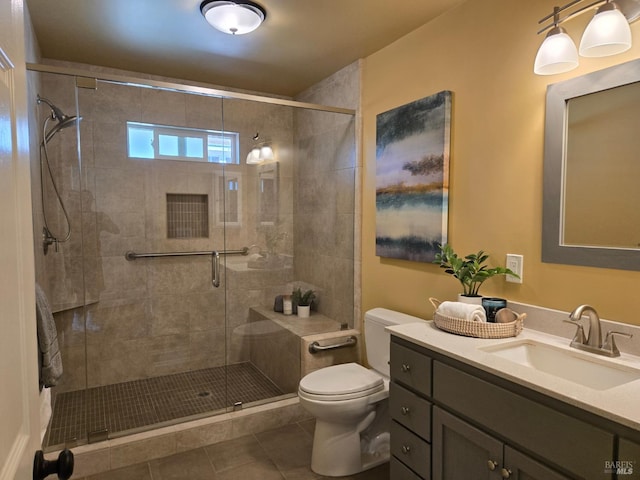 bathroom featuring vanity, tile patterned flooring, toilet, and walk in shower