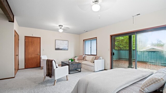 bedroom with ceiling fan, beam ceiling, light colored carpet, and access to outside