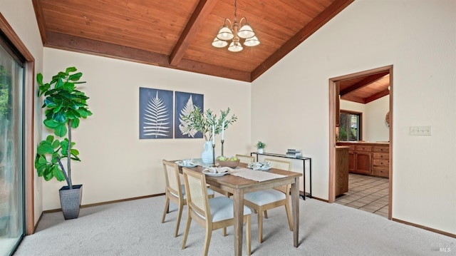 dining space featuring a notable chandelier, lofted ceiling with beams, light colored carpet, and wooden ceiling