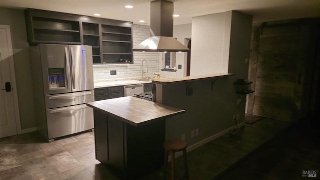 kitchen featuring a kitchen breakfast bar, island exhaust hood, stainless steel appliances, light countertops, and open shelves