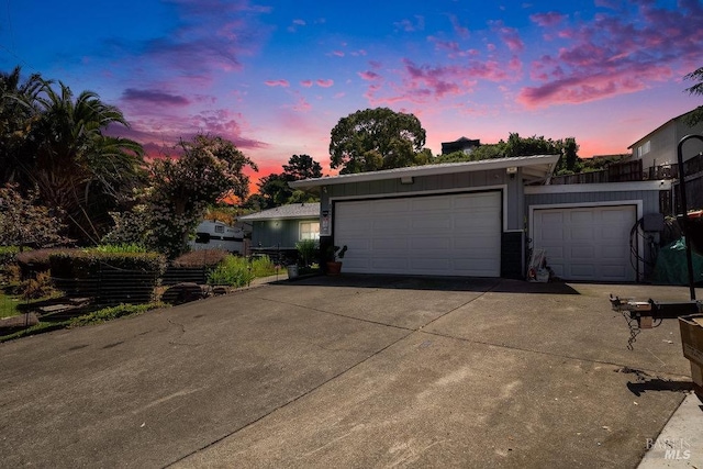 garage featuring concrete driveway