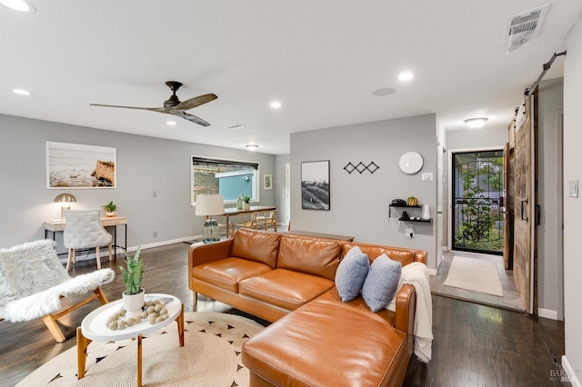 living room featuring a healthy amount of sunlight, visible vents, dark wood-style flooring, and recessed lighting