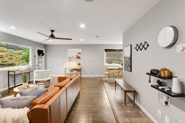 living room with recessed lighting, plenty of natural light, and baseboards