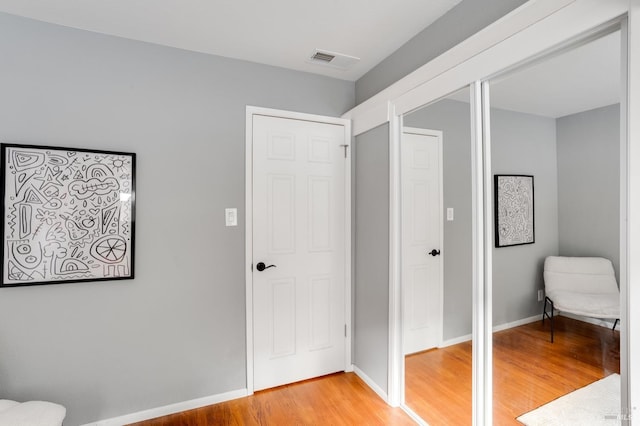 bedroom with visible vents, baseboards, and wood finished floors