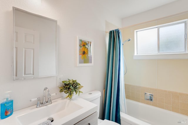 bathroom with shower / tub combo, vanity, and toilet