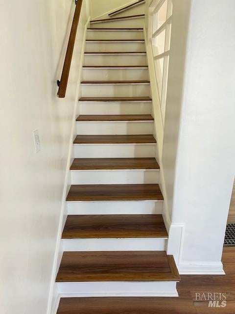 staircase with wood-type flooring