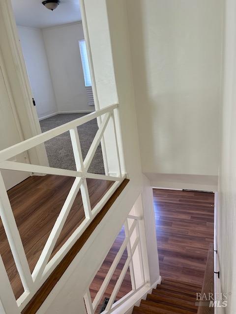 stairs featuring dark hardwood / wood-style floors