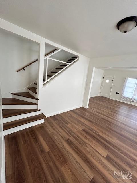 staircase featuring dark hardwood / wood-style floors