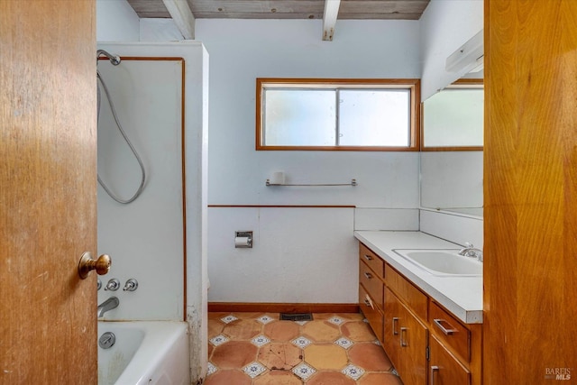 full bathroom featuring washtub / shower combination, vanity, and baseboards