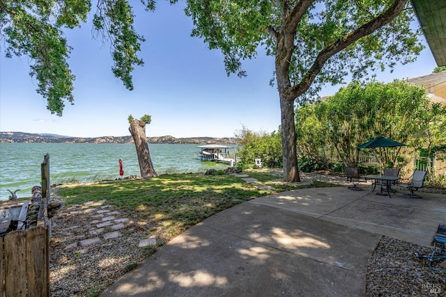 view of yard with a patio area and a water view