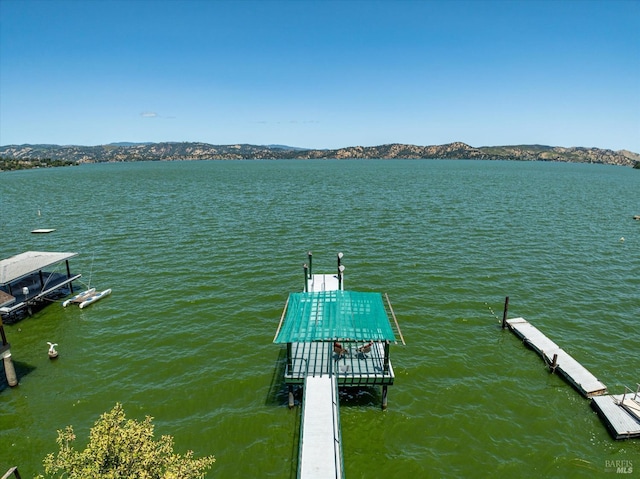 view of dock featuring a water and mountain view