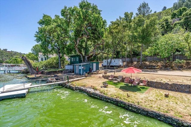 dock area featuring a water view and fence