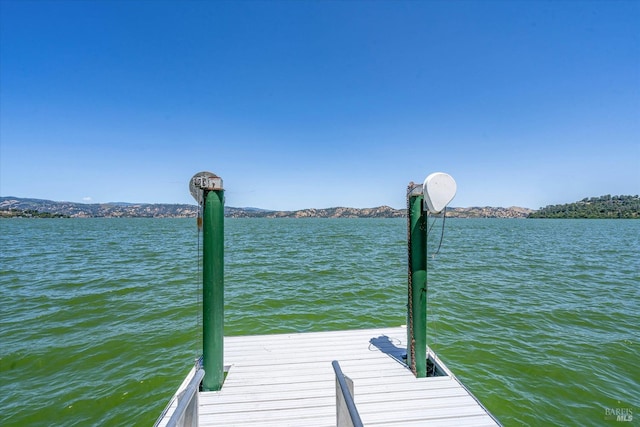 dock area featuring a water and mountain view