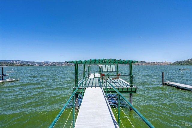 view of dock with a water and mountain view