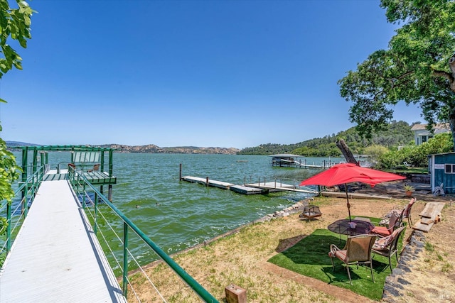 view of dock with a water and mountain view