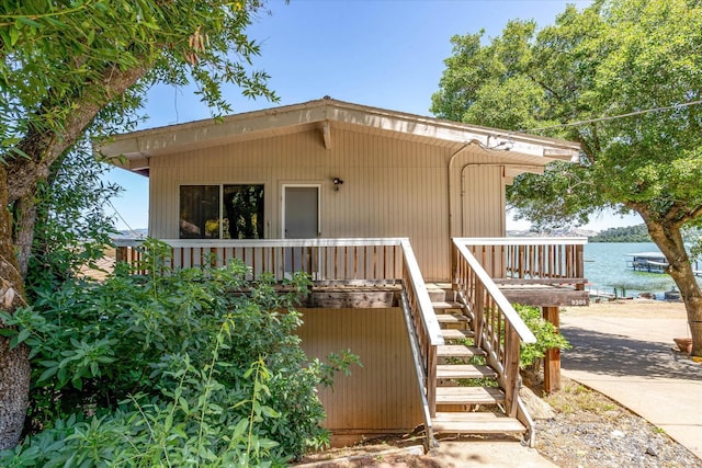 exterior space with a water view and stairway