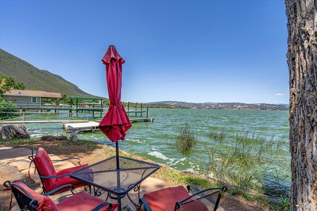 exterior space with a dock and a mountain view