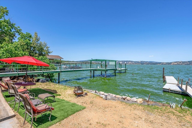 view of dock featuring a water and mountain view