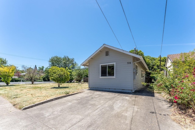 view of side of property with a yard