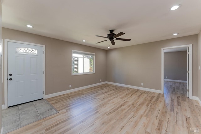 foyer entrance with light wood-type flooring and ceiling fan