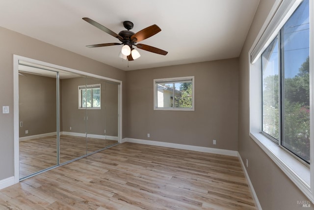 unfurnished bedroom with ceiling fan, a closet, and light hardwood / wood-style floors