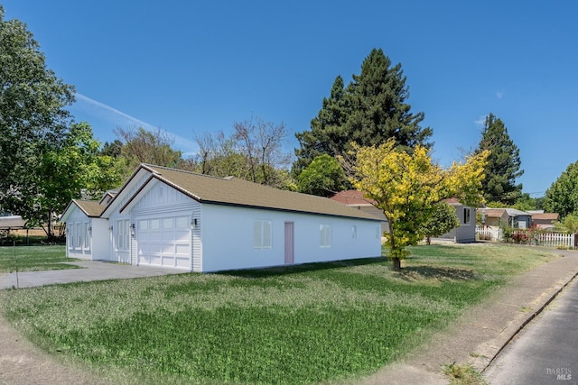 exterior space with a garage and a yard